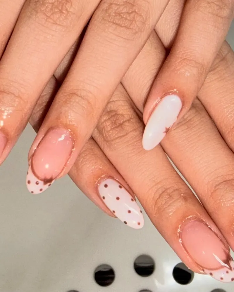 Nude nails with polka dots and hand-painted bows